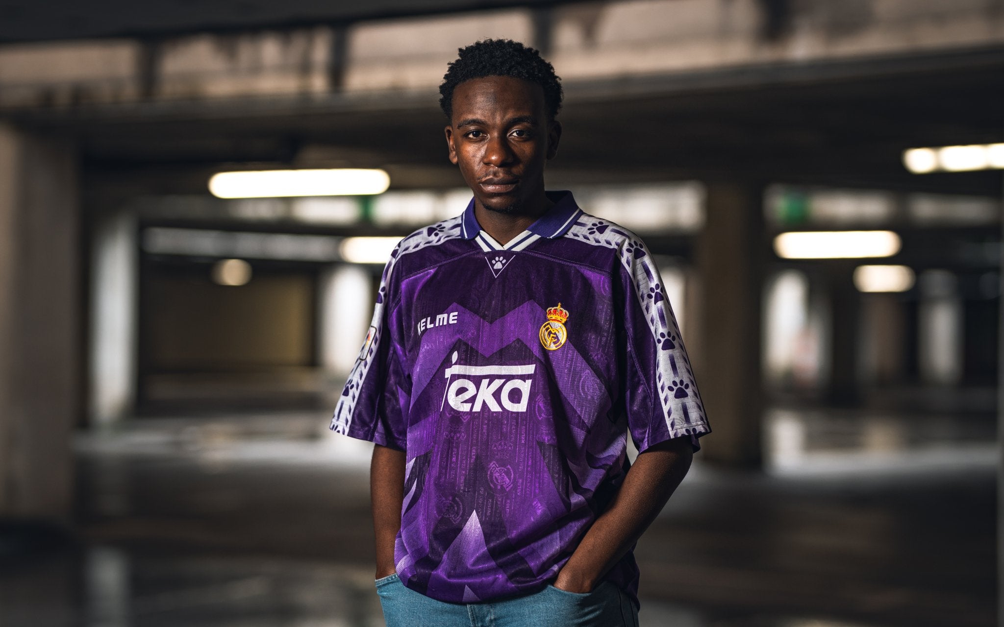 Person wearing a purple sports jersey with visible branding in an indoor setting